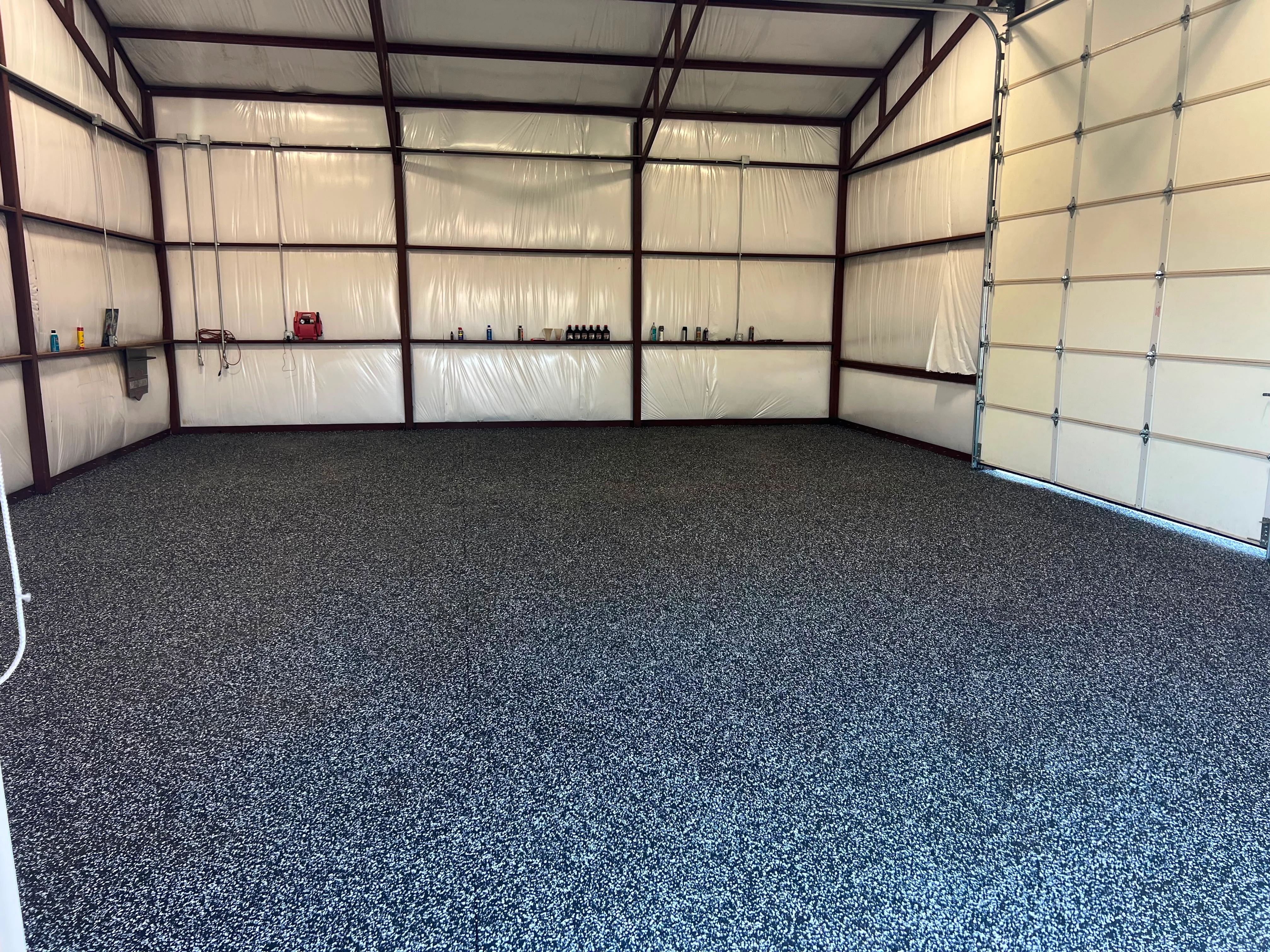 Epoxy garage floor with steel frame walls and polycarbonate panels